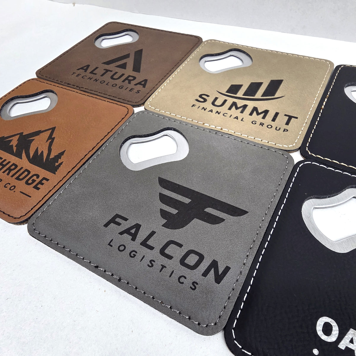 Gray, tan, and rawhide leatherette coaster bottle openers with black engraving